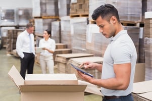 Portrait of male manager using digital tablet in warehouse Credit: Shutterstock