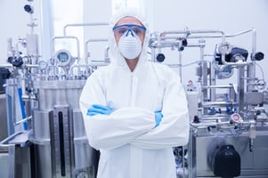 Scientist in protective suit standing with arms crossed in the factory Image: Shutterstock