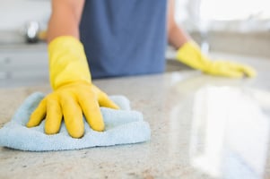 Woman cleaning the counter in the kitchen Image: Shutterstock