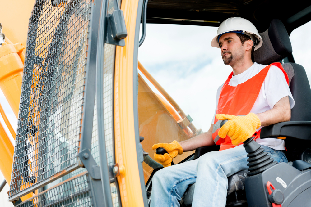 Worker operating a crane at a construction site